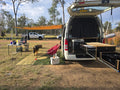 Eco-friendly outdoor mat under van awning with dog, perfect for camping and caravan trips