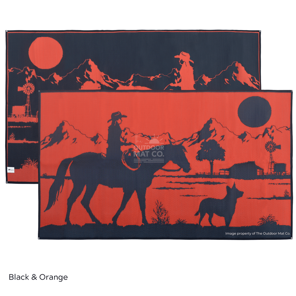 Black and orange recycled outdoor mat with cowboy, horse, dog, mountains, and windmill design for camping or beach use