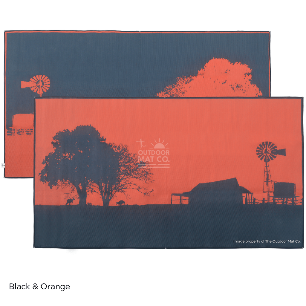 Black and orange recycled outdoor mat with farm silhouette, windmill, and trees for camping or picnics