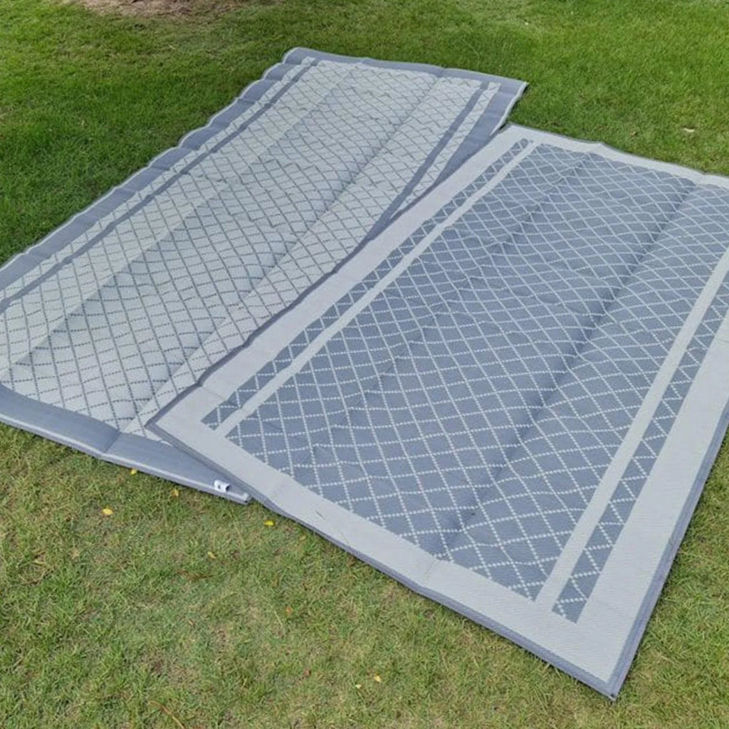 Recycled outdoor mats with diamond pattern on grass, ideal for picnics, camping, beach days
