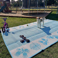 Blue and white recycled outdoor mat with bike and flower patterns, perfect for picnics, camping, or beach days with pets and kids.