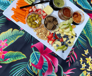Tropical print outdoor mat with charcuterie board, perfect for picnics, beach days, and camping adventures.
