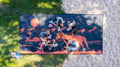 Group enjoying picnic on large outdoor mat with sunset horse design, perfect for beach or park outings.
