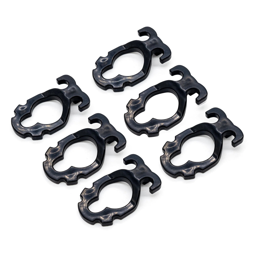 Black plastic mat anchors for securing outdoor mats on sand, grass, or camping grounds