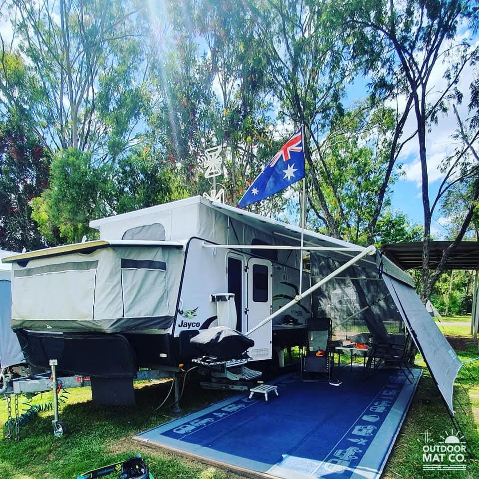 Blue recycled outdoor mat under caravan awning, perfect for camping & beach days