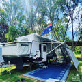 Blue recycled outdoor mat under caravan awning, perfect for camping & beach days
