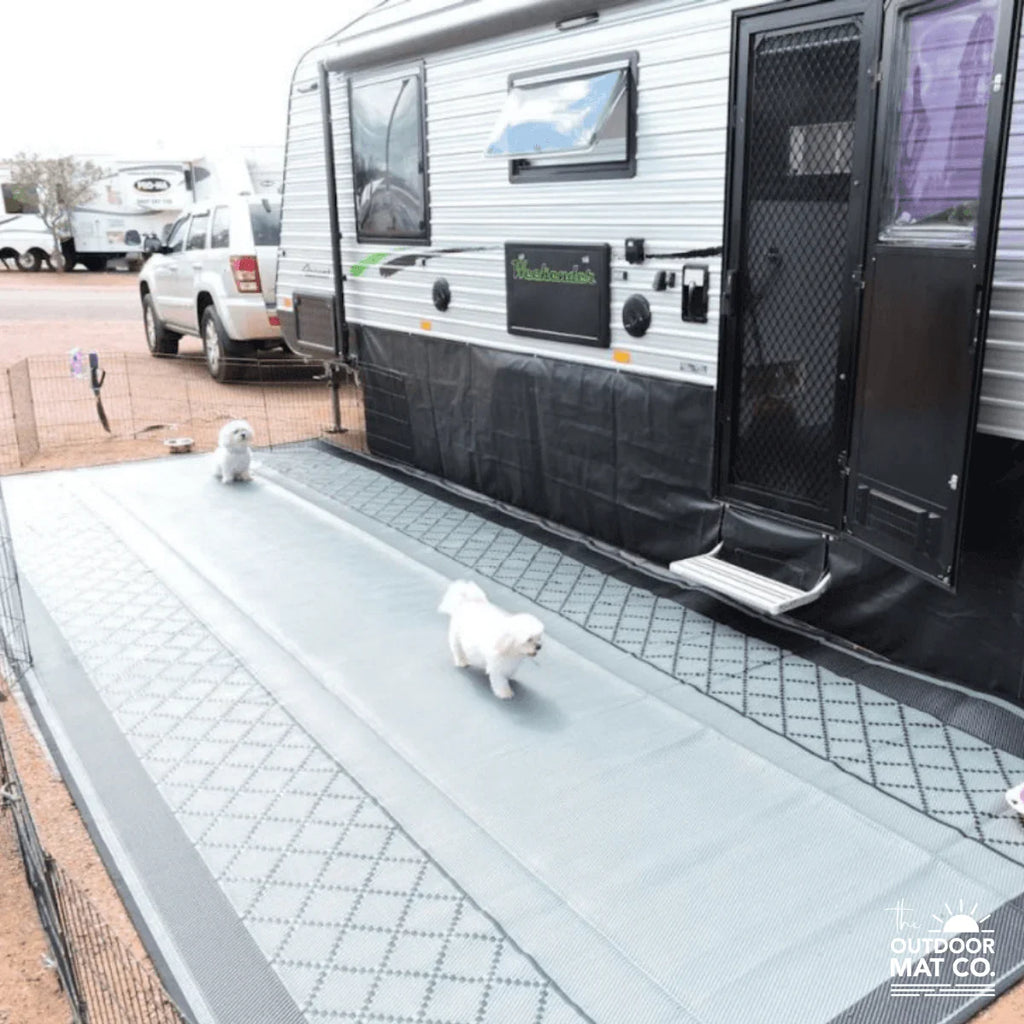 Recycled outdoor mat for caravans with dogs walking on it, durable and sand-friendly design