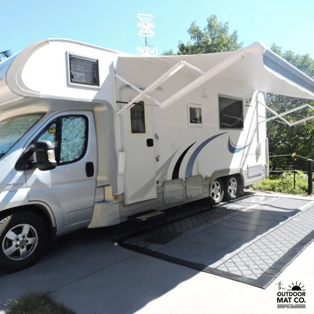 Recycled outdoor mat under caravan awning, perfect for camping and beach days
