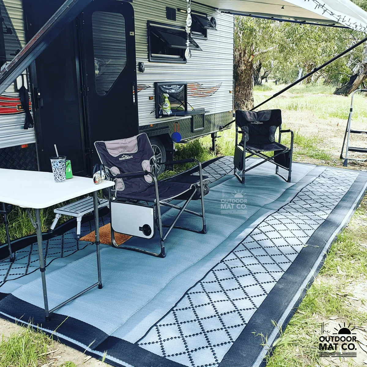 Recycled outdoor mat under caravan awning with camping chairs and table, perfect for caravan trips and picnics
