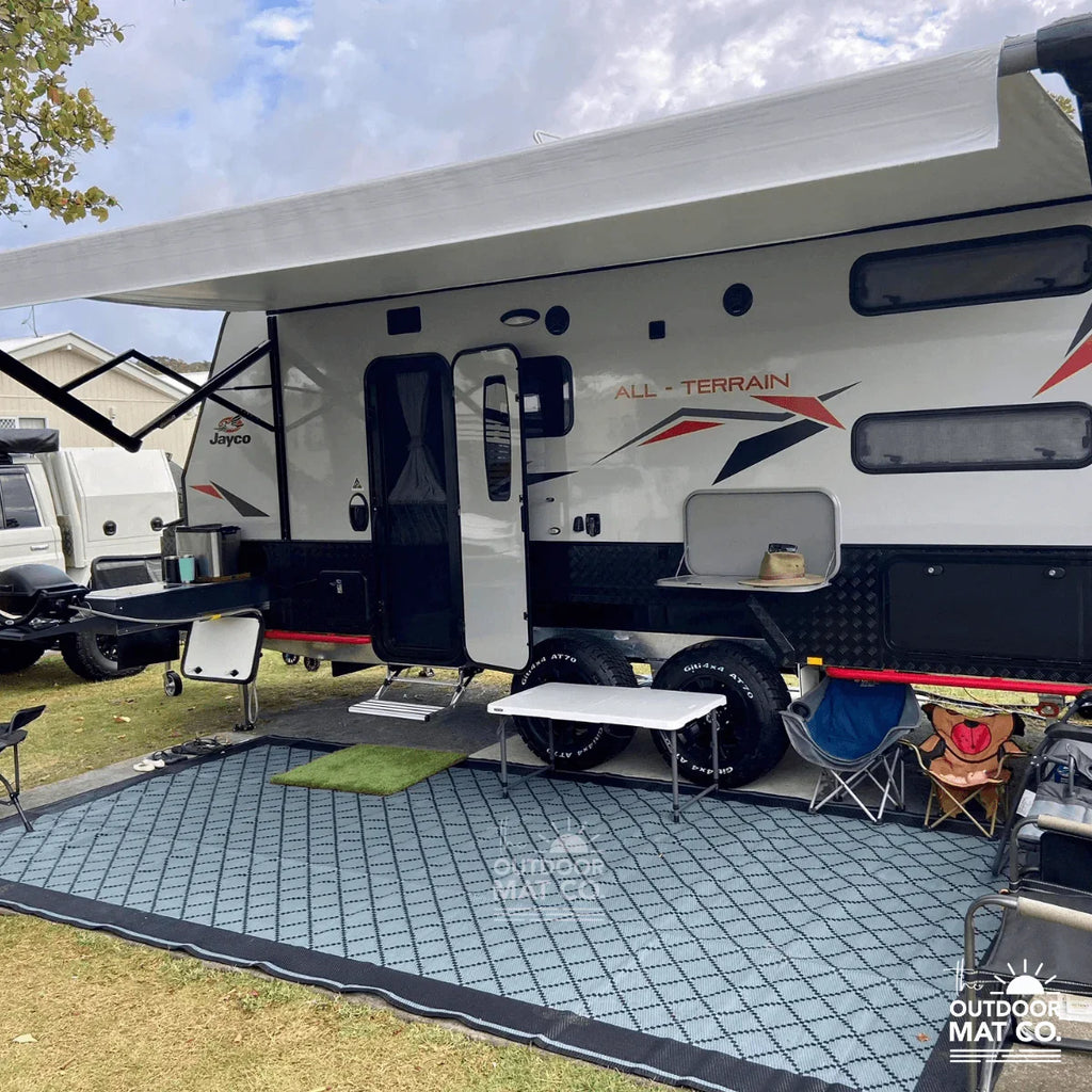 Recycled outdoor mat under caravan awning, perfect for camping, picnics, and beach days with durable, eco-friendly design.