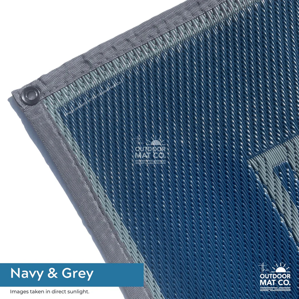 Navy & grey recycled outdoor mat with durable woven texture, ideal for beach, camping, picnics, and caravans.
