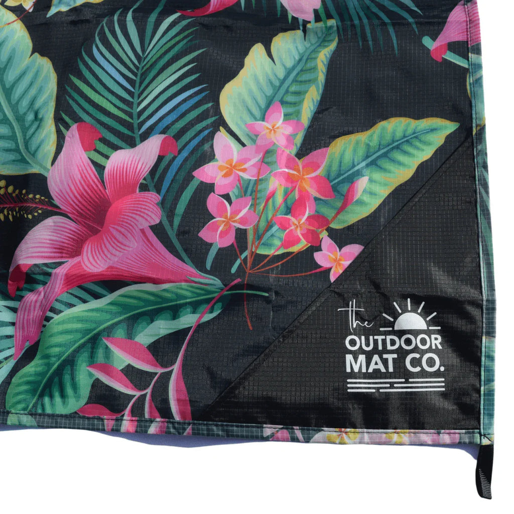 Tropical floral outdoor mat with pink flowers and green leaves, eco-friendly for beach or camping